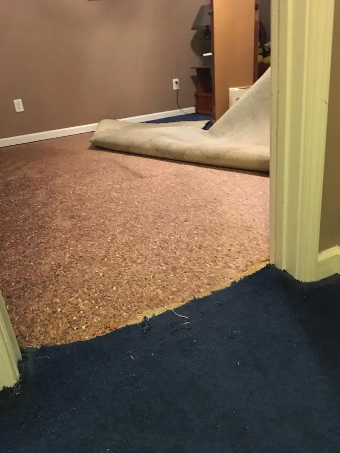 Carpet pad removal revealing water damage during Drying & Dehumidification in Graham